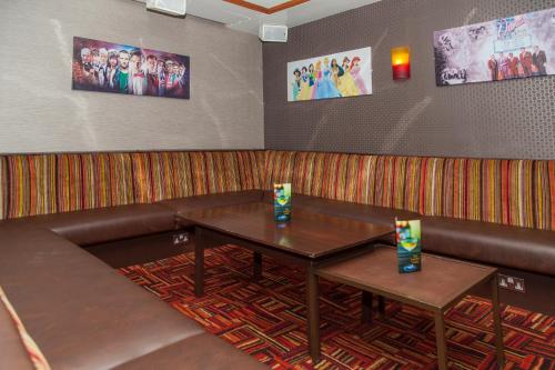 a booth with a table and a leather couch at The Lawton in Blackpool
