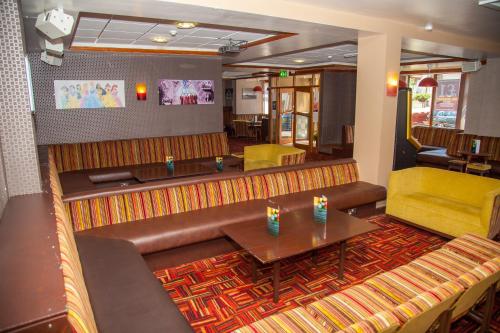 a restaurant with a couch and a table and chairs at The Lawton in Blackpool