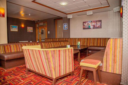 a restaurant with a table and chairs and a couch at The Lawton in Blackpool