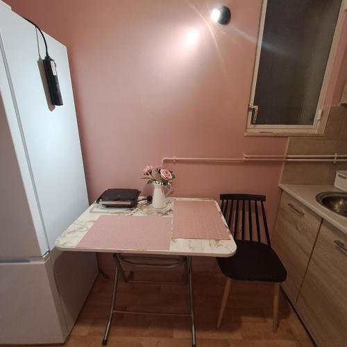 a small kitchen with a table with a laptop on it at Riga Fereou apartments in Patra