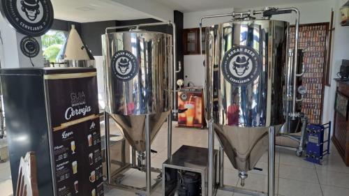 a room with two large silver tanks in a room at POUSADA ARKAN BEACH in Saquarema