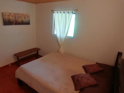 a bedroom with a bed and a window at Nuestro Bosque I in Tena
