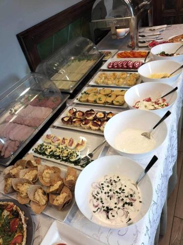 a buffet table with many different types of food at Hotel Kresowianka in Konin