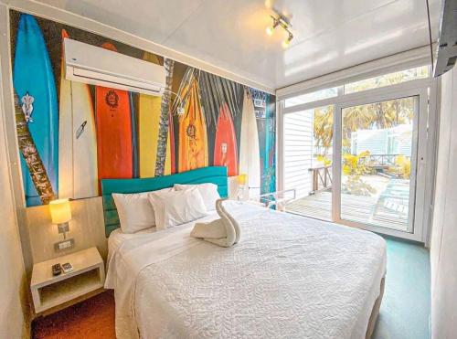 a bedroom with a bed with surfboards on the wall at Hotel Reina del Mar By Dorado in San Andrés