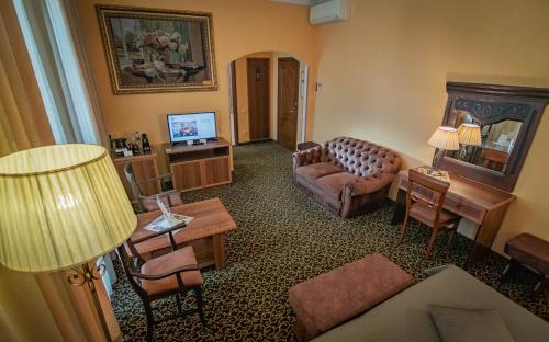a living room with a couch and a television at Premier Hotel Palazzo in Poltava