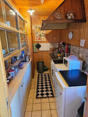 a small kitchen with a stove and a sink at L'ancien hospice in Bourg-Saint-Pierre