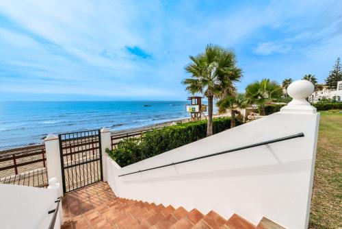 a white fence with the beach in the background at Playa Lucera in Sitio de Calahonda