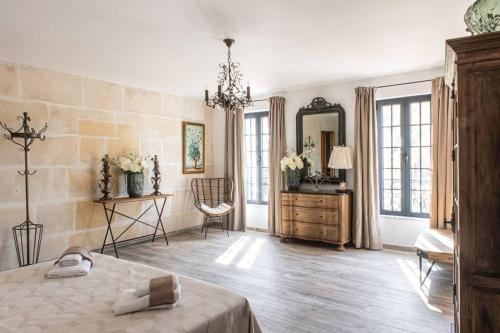 um quarto com uma cama, uma cómoda e um espelho em Mas Mandine, en Provence em Arles