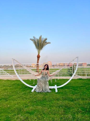 a woman in a dress posing in front of a hoop at Royal Nile Villa - Pool View Apartment 1 in Luxor