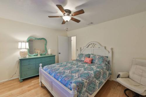 a bedroom with a bed and a ceiling fan at Lazy Manatee Pool Home in Bradenton