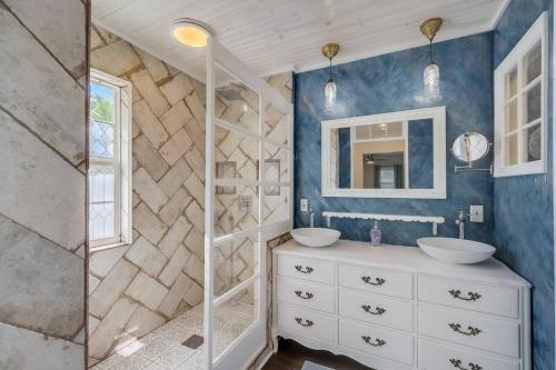 a bathroom with two sinks and a mirror at The Nest in Sarasota