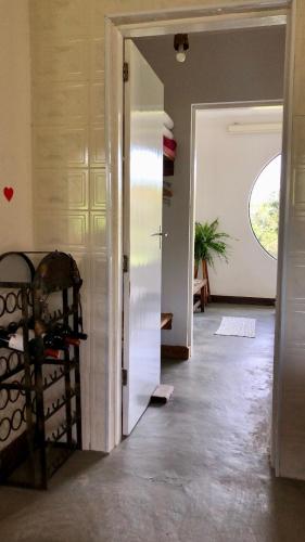a hallway with a door open to a room at Atma Anna in Piedade
