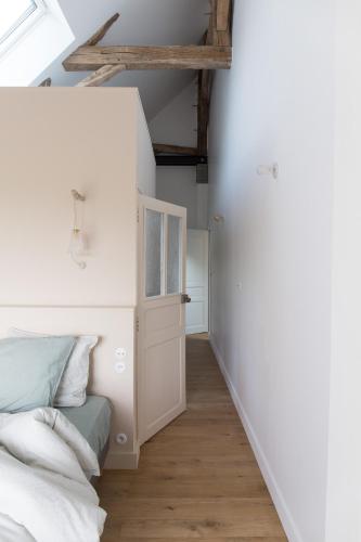 Ένα ή περισσότερα κρεβάτια σε δωμάτιο στο Maison d'hôtes le détour en pleine nature