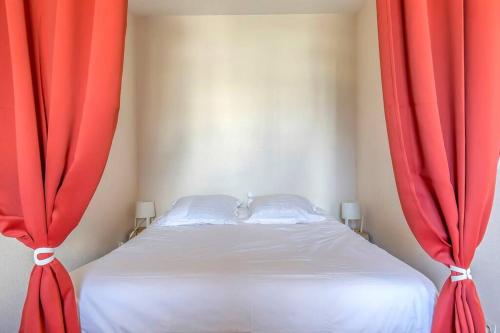 a bed with red curtains in a bedroom at Maupassant: T1bis lit 160 - clim - parking gratuit in Grenoble