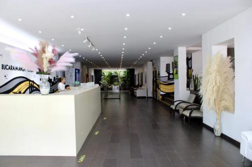 a lobby of a store with a counter and chairs at Hotel Bucaramanga Plaza in Bucaramanga