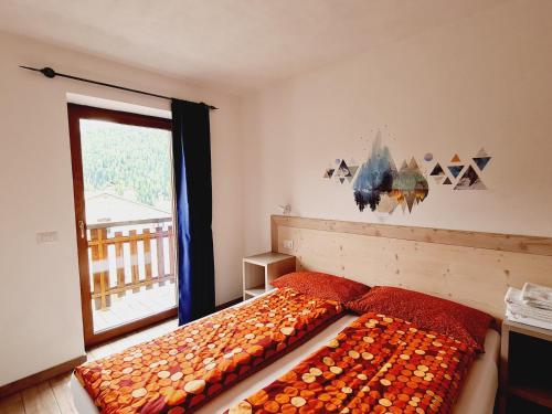 a bedroom with two beds in front of a window at Chalet Selva in Valdidentro