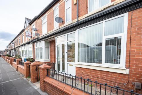 a row of windows on a brick building at M6 Guest House in Manchester