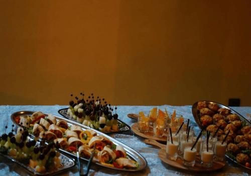 a table with several trays of food and drinks at PARAISO DAKHLA in Dakhla