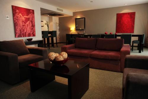 a living room with two couches and a table at Epic Hotel San Luis in La Punta