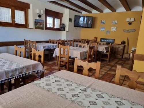 un restaurante con mesas y sillas en una habitación en Las Abadías en San Felices