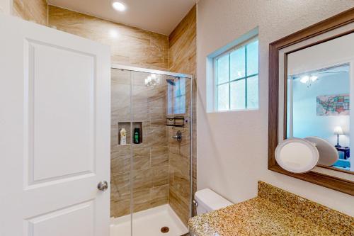 a bathroom with a shower with a glass door at The Geography House in Montgomery