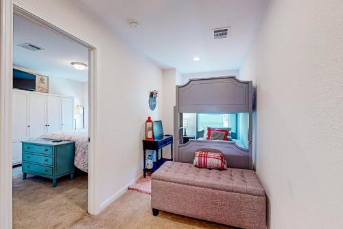 a bedroom with a bed and a chair and a mirror at The Geography House in Montgomery