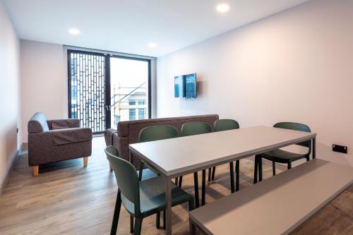 una sala de espera con mesa y sillas en Coleman Court Summer Apartments en Cork