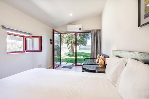 a bedroom with a white bed and a window at VIVA Serralves Vintage House in Porto