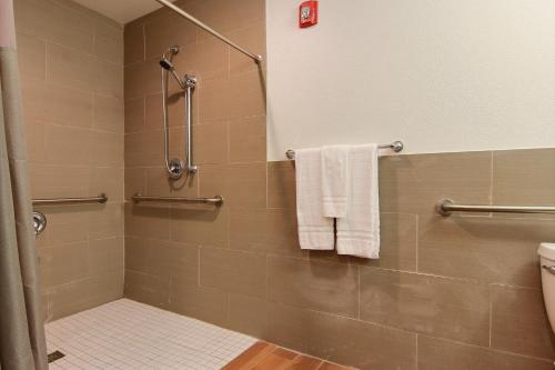 a bathroom with a shower with white towels at Motel 6-Rockport, TX in Rockport