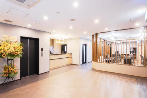 a lobby with a waiting area and a restaurant at Pearl Spring116 hotel in Osaka