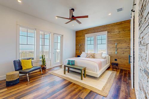 a bedroom with a bed and a ceiling fan at SBSL706 Luxury, Ocean front beach house, Hot Tub, Boardwalk to Beach in Port Aransas