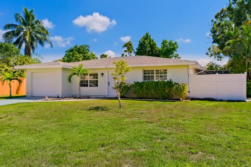 a white house with a green yard at Lounging Palms Estate in Fort Myers