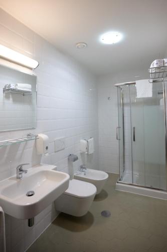 a bathroom with a toilet and a sink and a shower at Casa I Cappuccini in Rome