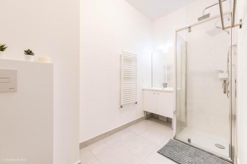 a white bathroom with a shower and a sink at Bouton d'Or for 4 - Fairytale Factory in Ferrières-en-Brie