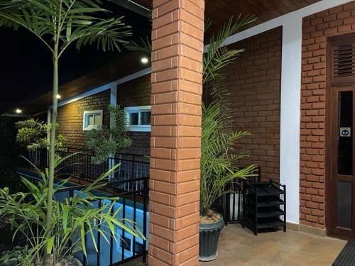 a brick pillar with plants in front of a building at The Tenthola in Kandy