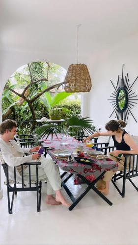 a man and a woman sitting at a table at The Kilimanjaro Villa in Moshi