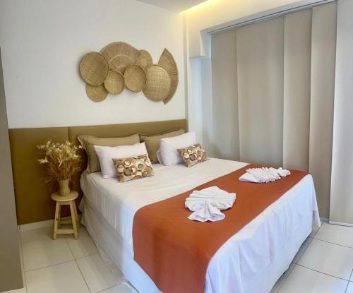 a bedroom with a bed with towels on it at Porto Beach Resort - Makia Beach Experience in Porto De Galinhas