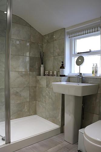 a bathroom with a shower and a sink and a toilet at The Lodge in Rempstone