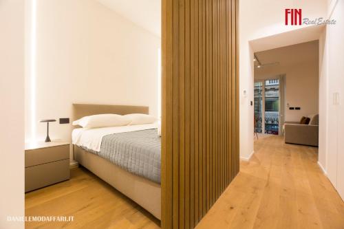 a bedroom with a bed and a large wooden partition at Mazzini House by Holiday Home 24 in Genova