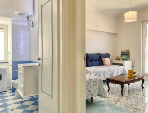 a bedroom with a bed and a table in a room at CasaViva - Family Home in Santa with AC in Santa Margherita Ligure