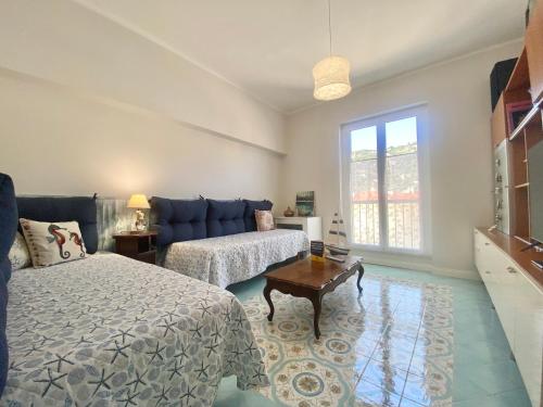 a bedroom with a bed and a couch at CasaViva - Family Home in Santa with AC in Santa Margherita Ligure