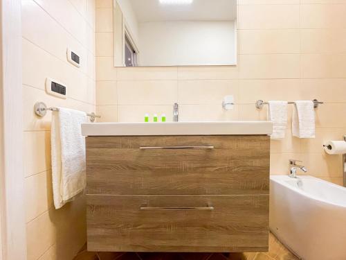 a bathroom with a sink and a mirror at Brain Penthouse Pagani in Pagani