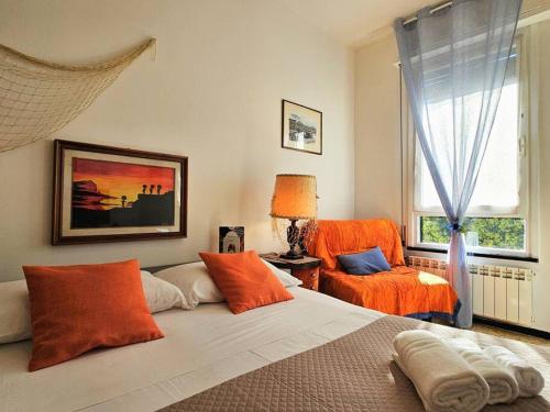a bedroom with a bed and a chair and a window at [ Portofino ] Centro di Rapallo in Rapallo