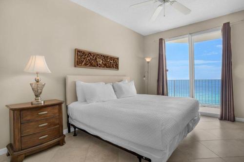 a bedroom with a bed with a view of the ocean at Majestic Sun 904B in Destin