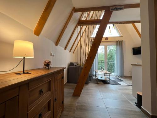 a living room with a vaulted ceiling with wooden beams at Alpi Cabin Pridolci in Busovača