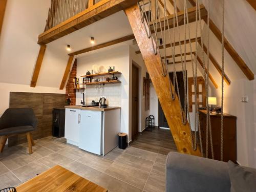 a kitchen and living room with a staircase in a house at Alpi Cabin Pridolci in Busovača