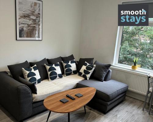 a living room with a couch and a coffee table at Modern 2 Bed Apartment By Smooth Stays Short Lets & Serviced Accommodation Preston With Parking Near Train Station in Preston
