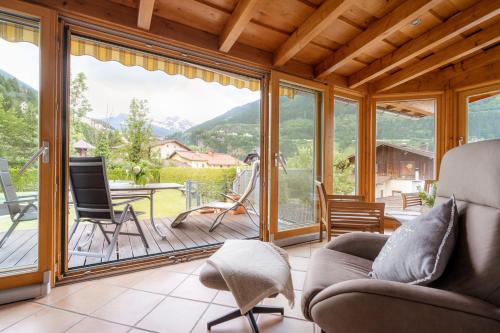 a living room with sliding glass doors and a patio at Ferienwohnungen Badbruckerweg- Bad Gastein in Bad Gastein