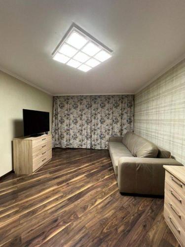 uma sala de estar com um sofá e uma televisão em Naruto holiday home em Ranelagh