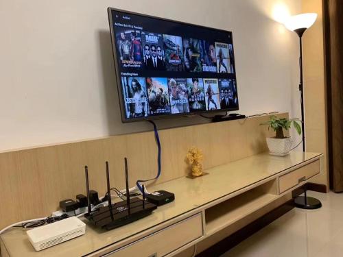 a flat screen tv on a wall in a living room at The Floorspace Imperial Suites Apartment 2 in Kuching